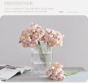 Pink and yellow silk roses in glass vase with magazines for minimalist home decor