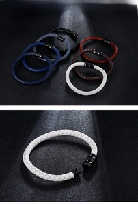 Close-up of multicolored braided leather bracelets featuring a black magnetic steel clasp