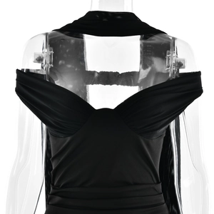 Detail of elegant black strapless dress featuring a draped neckline and ruched bodice detail