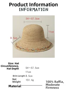 Detail view of woven raffia sun hat showing elegant floral embroidery and brim dimensions