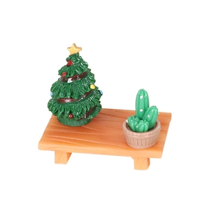 Miniature Christmas tree with colorful baubles and cactus on wooden table for DIY decor