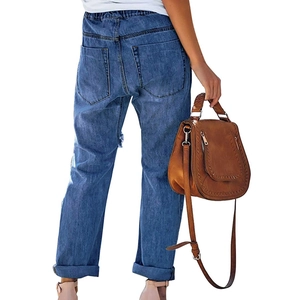 Classic loose blue distressed jeans with elastic drawstring waist, back view on model