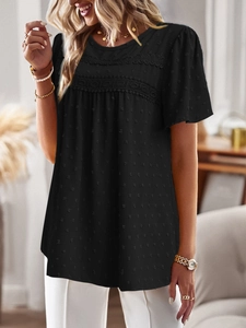 Detail of black short sleeve top featuring lace拼接 and textured polka dot jacquard fabric