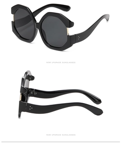 Detailed macro view of oversized cat-eye sunglasses with triple metal rivets and dark lenses