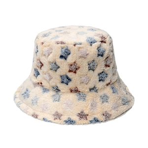 Close-up of beige plush bucket hat featuring blue and brown star patterns and soft texture
