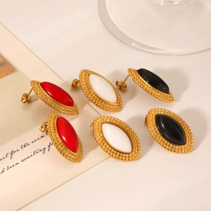 Detail of oval resin earrings with gold twisted borders in red, white and black colors