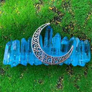 Detail of bohemian blue crystal moon crown featuring raw quartz and carved crescent moon