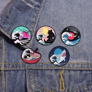 5pcs cartoon ocean enamel pin set with surfing cats and waves on blue denim jacket