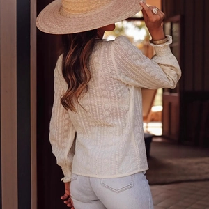 Detail of elegant beige embroidery and lace hollow-out on lady long-sleeve blouse
