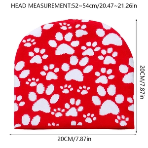 Size chart showing height and width of a red knit beanie with white paw print pattern