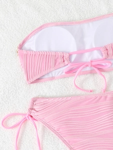 Detailed view of pink bikini top showing internal lining and wavy fabric texture