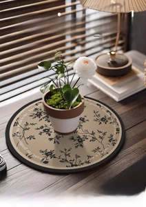 Close-up of French vintage floral absorbent leather mat on a wooden desk with warm lighting