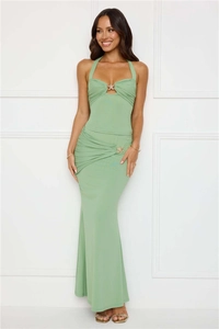 Detail of gold metal hardware on waist ruching and cutout of green halter dress