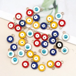 Close-up of colorful 8mm evil eye charms with gold metal edges for DIY jewelry making