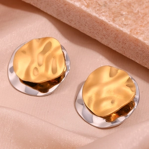 Macro shot of two-tone gold and silver irregular textured layered disk earrings