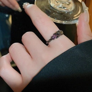 Gothic style black metal ring featuring a leopard head design with oval purple gemstone