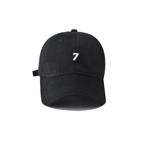 Close-up of white number 7 embroidery on a black cotton baseball cap with fine texture