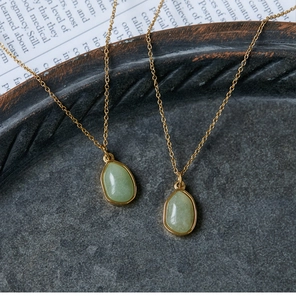 Detailed close-up of 18K gold plated necklace with green aventurine drop pendant