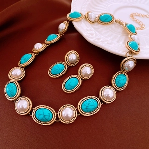 Detailed view of vintage gold necklace and earrings set with turquoise and pearls