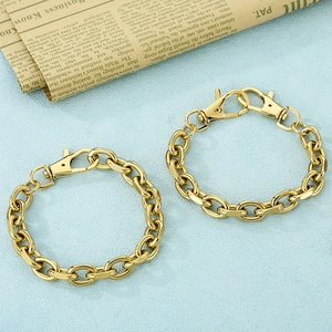 Detail view of gold stainless steel cable chain bracelets with lobster clasp closure