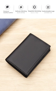 Detail of black lychee grain leather card holder with fine stitching on wood background