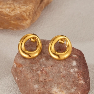 Minimalist gold-plated irregular round hoop earrings displayed on natural brown stones