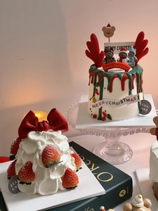 Detailed view of Christmas cake decorations with reindeer antlers and festive sign flags
