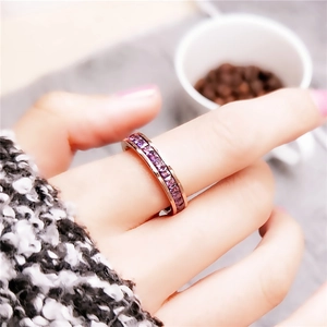 Minimalist rose gold ring with purple square-cut gemstones in a channel setting