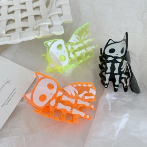 Spooky cat skeleton hair claws in neon green, orange, and black for Halloween styling
