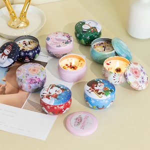 Detailed view of scented soy candles in decorative tins with dried flower petals and wicks