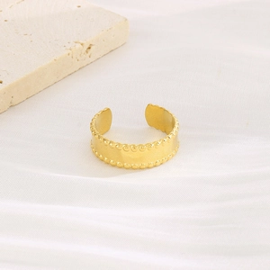 Detail of 18k gold plated C-shaped ring with matte finish and beaded edges on stone