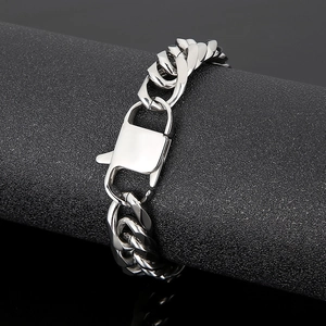 Macro detail of silver stainless steel curb chain bracelet with a rectangular hinge clasp