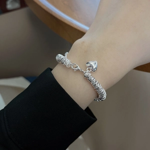 Minimalist silver wire-wrapped bracelet with a 3D heart pendant and lobster clasp