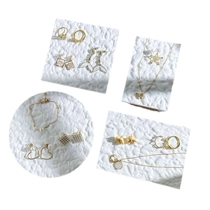 Ins style gold jewelry display tray with elegant pearl earrings and butterfly necklaces