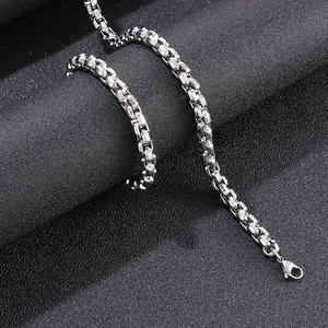 Macro shot of silver stainless steel box chain with lobster clasp on black background