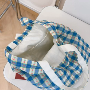 Internal view of the blue checkered floral tote bag showing its inner pocket and large capacity