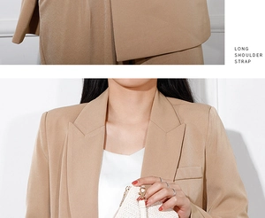 Detail of straw woven mini bag with adjustable long shoulder strap and golden clasp