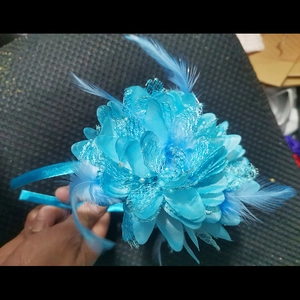 Detail view of blue feather flower headband with lace and pearls for bridal party
