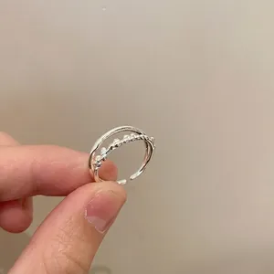 Detail of silver double-layered open ring featuring beaded texture and minimalist band