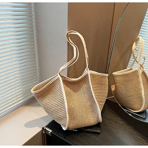 Detail of hollow woven straw handbag in khaki and white trim for summer fashion