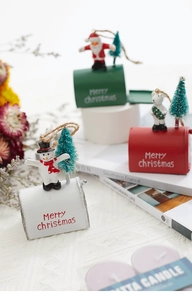 Close-up of miniature Christmas mailboxes featuring Santa, snowman, and polar bear figures