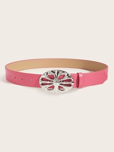 Detailed close-up of a pink leather belt with an ornate silver floral hollow buckle