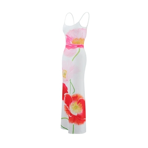 Detail of slim-fit white maxi dress featuring vibrant red and pink poppy flower prints