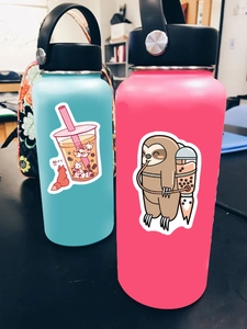 Waterproof cartoon bubble tea stickers applied on blue and pink stainless steel bottles