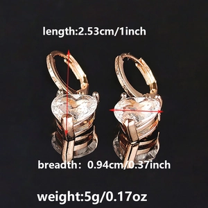 Macro shot of rose gold heart earrings with zircon studs showing size and weight specs