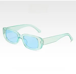 Detail view of vintage small rectangle green frame sunglasses with blue lenses