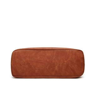 Detailed base view of brown lychee grain leather tote bag with rectangular structure