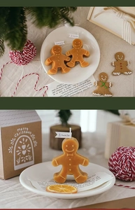 Detailed view of gingerbread man scented candles with Christmas gift box packaging