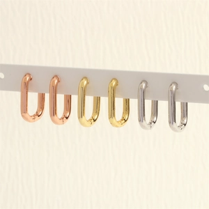 Three pairs of U-shaped geometric hoop earrings in gold, silver, and rose gold finishes