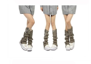Detailed view of olive green knitted leg warmers featuring functional metal zipper closure